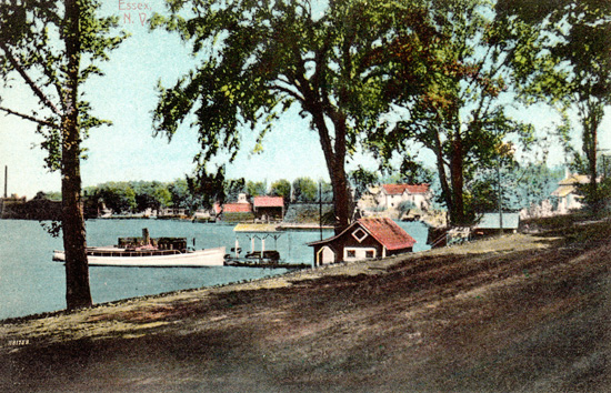 Rosslyn bathhouse, boathouse, and the steam yacht, Kestrel, are center foreground, the Old Dock is center background with Essex Horse Nail Co. Factory at far left. (Source: Shirley LaForest via Essex on Lake Champlain)