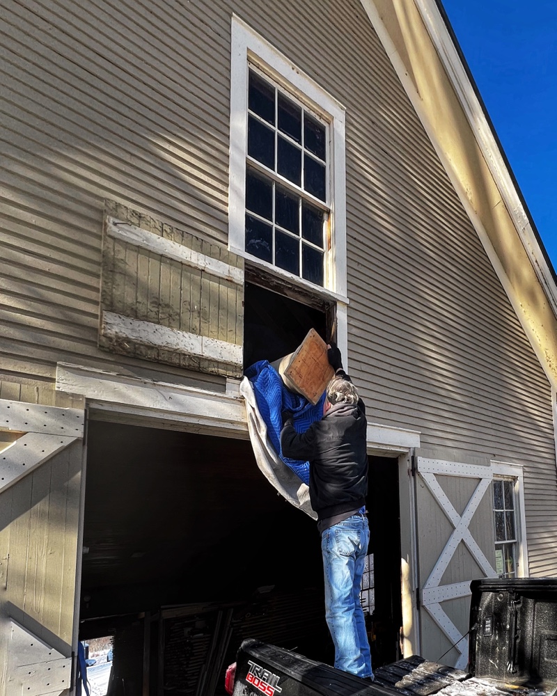 Hroth transporting repurposed columns from carriage barn hayloft to icehouse. (Photo: R.P. Murphy)